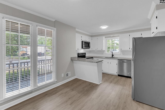 kitchen with white cabinetry, sink, stainless steel appliances, light hardwood / wood-style floors, and ornamental molding