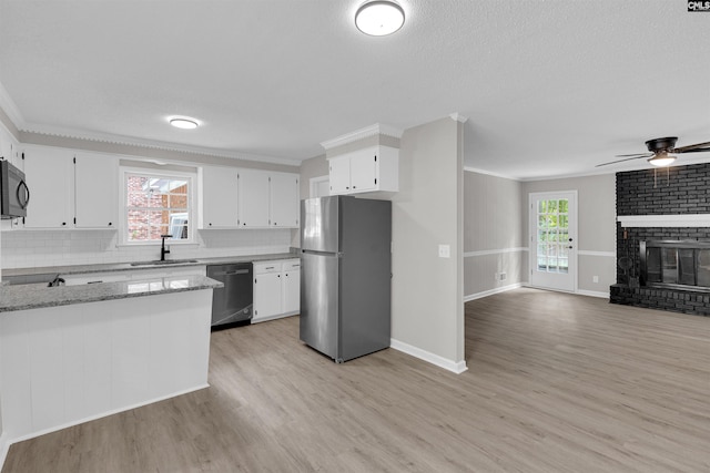 kitchen featuring plenty of natural light, light hardwood / wood-style floors, white cabinetry, and appliances with stainless steel finishes