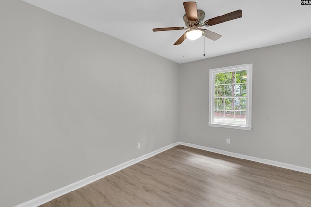 empty room featuring ceiling fan and hardwood / wood-style flooring