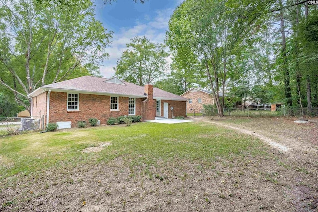 rear view of property with a yard and a patio