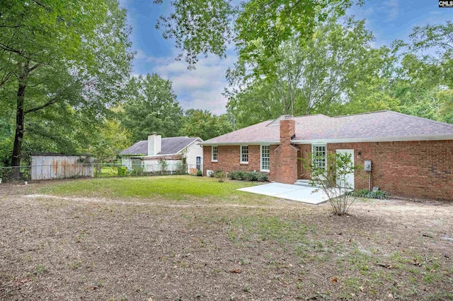 view of front of home featuring a front lawn and a patio area