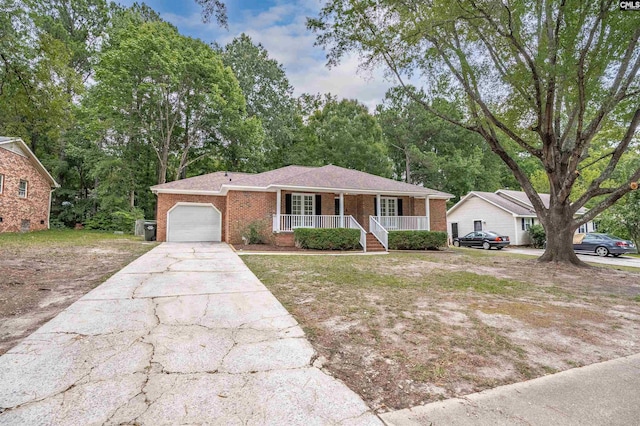 ranch-style home with covered porch and a garage