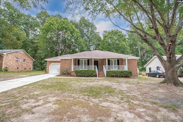 single story home featuring covered porch and a garage