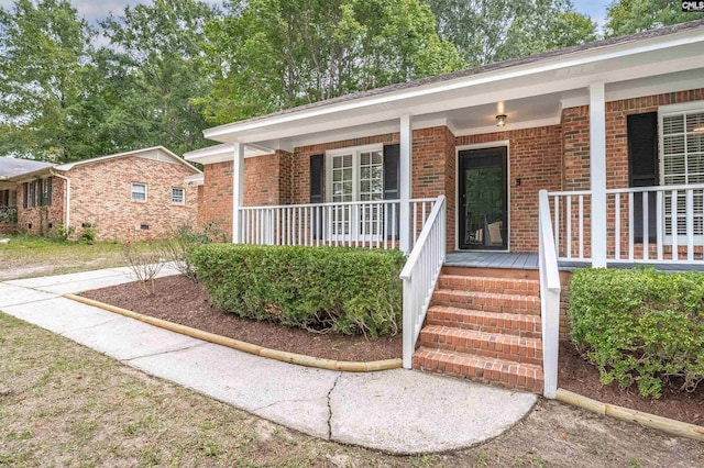 doorway to property featuring covered porch