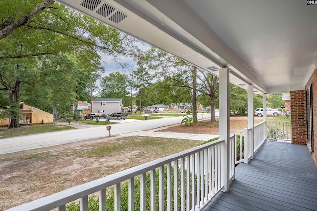 wooden terrace featuring covered porch