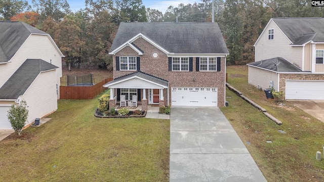 view of front facade featuring a trampoline, a front lawn, a porch, and a garage