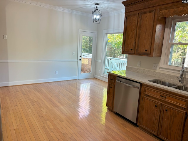 kitchen featuring ornamental molding, light hardwood / wood-style floors, stainless steel dishwasher, and a healthy amount of sunlight