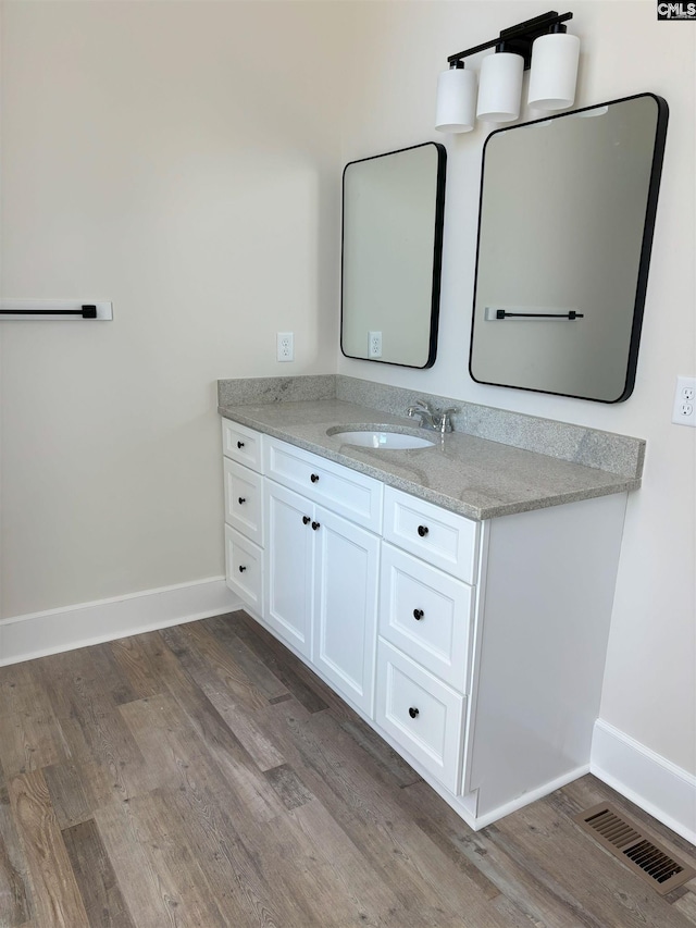 bathroom featuring hardwood / wood-style floors and vanity