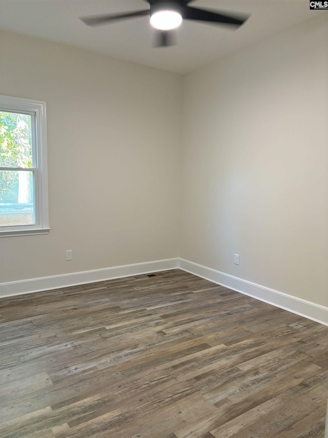 unfurnished room featuring ceiling fan and dark hardwood / wood-style flooring