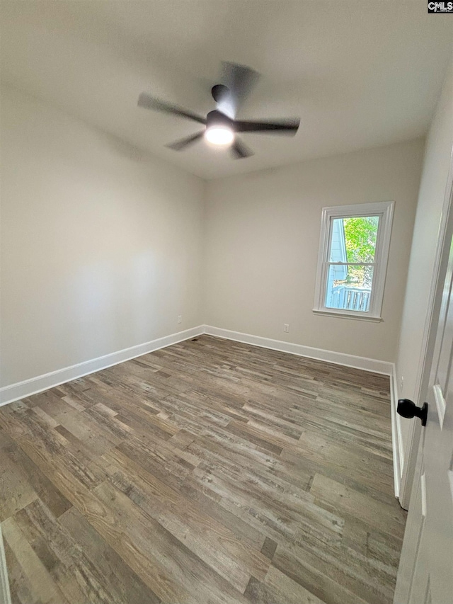 empty room with ceiling fan and hardwood / wood-style floors