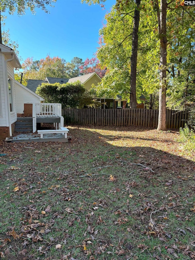 view of yard with a wooden deck