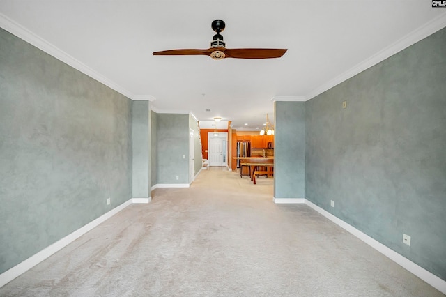 unfurnished living room featuring light carpet, ceiling fan with notable chandelier, and crown molding