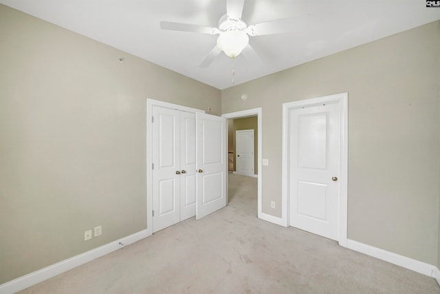 unfurnished bedroom with ceiling fan and light carpet