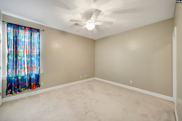 carpeted empty room featuring ceiling fan