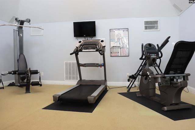 workout room featuring light carpet