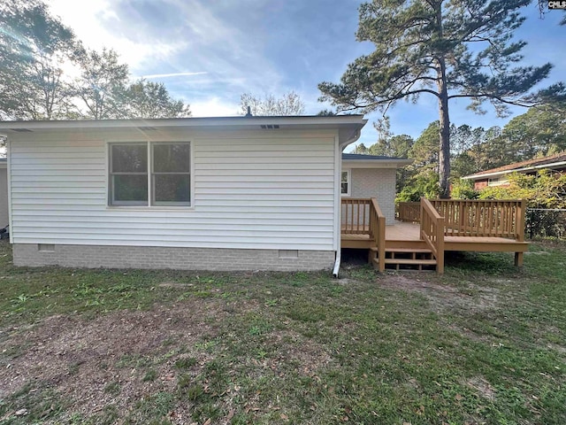 rear view of house featuring a wooden deck