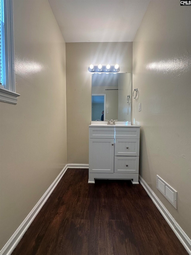 bathroom with hardwood / wood-style floors and vanity