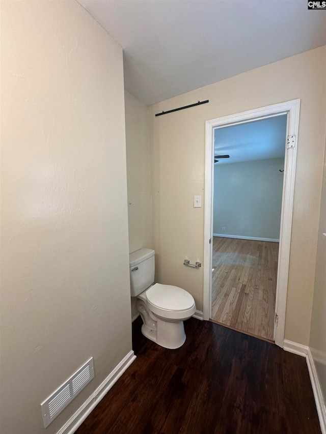 bathroom featuring hardwood / wood-style floors and toilet