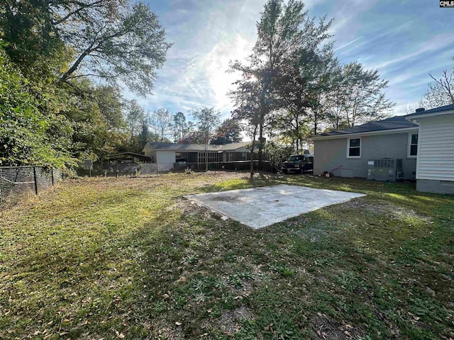 view of yard featuring central AC unit and a patio