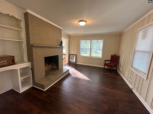 unfurnished room with a stone fireplace, ornamental molding, and dark wood-type flooring