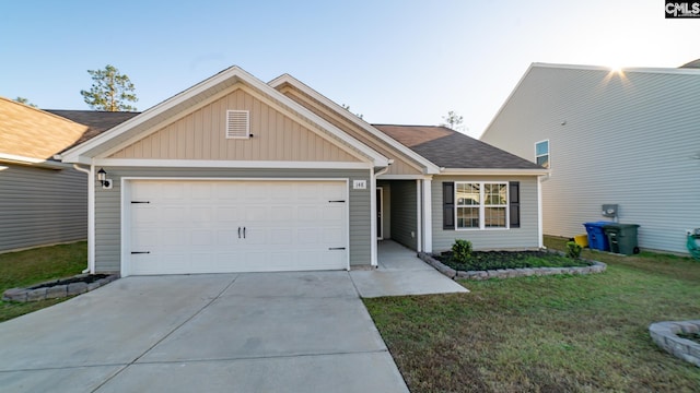 view of front of property featuring a garage and a front lawn