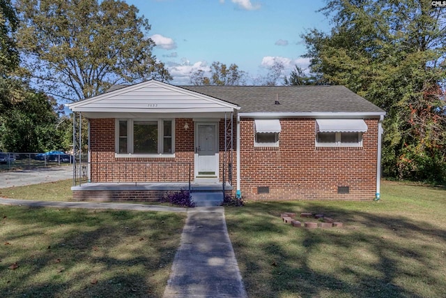 bungalow-style home featuring a front yard