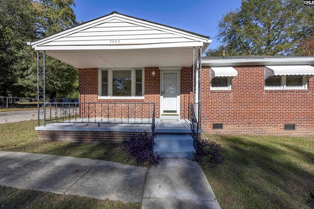 bungalow with a porch and a front lawn