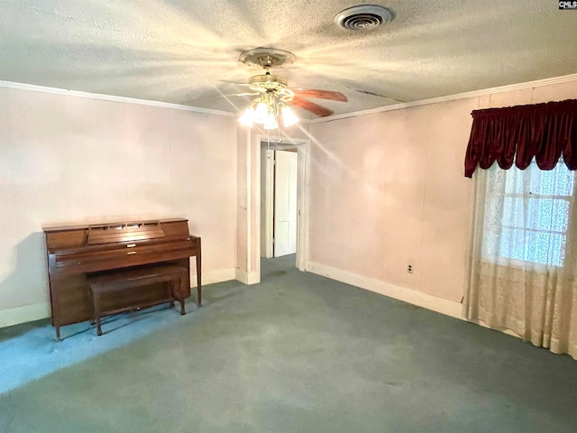 empty room featuring carpet flooring, a textured ceiling, and crown molding