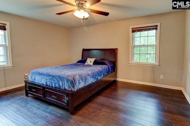 bedroom featuring a textured ceiling, dark hardwood / wood-style flooring, and ceiling fan