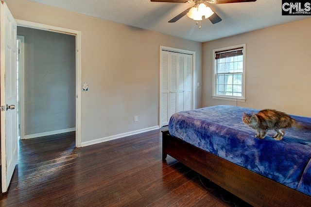 bedroom with a closet, ceiling fan, dark hardwood / wood-style flooring, and a textured ceiling