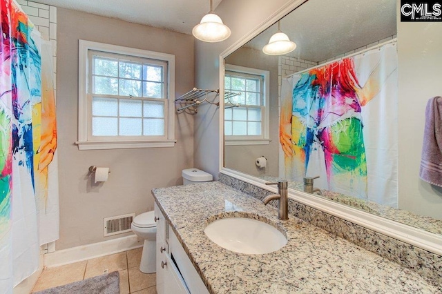 bathroom with tile patterned floors, vanity, curtained shower, and toilet