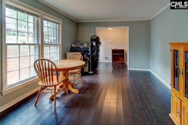 dining space with dark hardwood / wood-style flooring, ornamental molding, and a textured ceiling