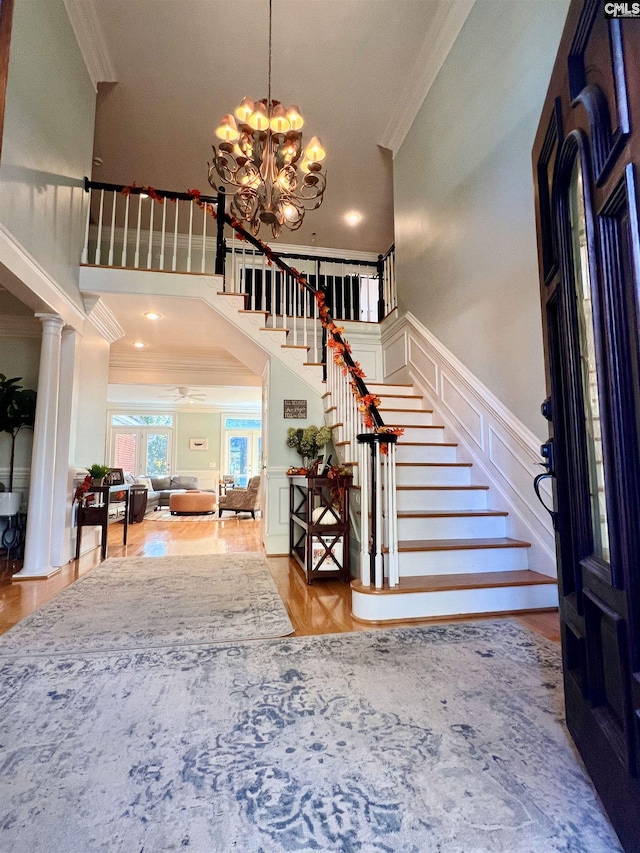 entryway featuring a chandelier, light hardwood / wood-style flooring, and crown molding