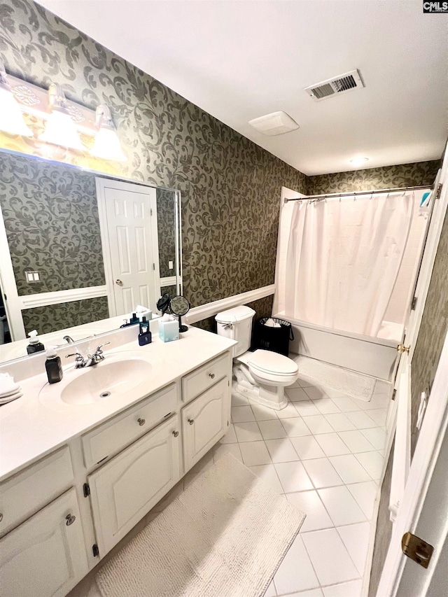 full bathroom featuring toilet, vanity, tile patterned floors, and shower / tub combo with curtain