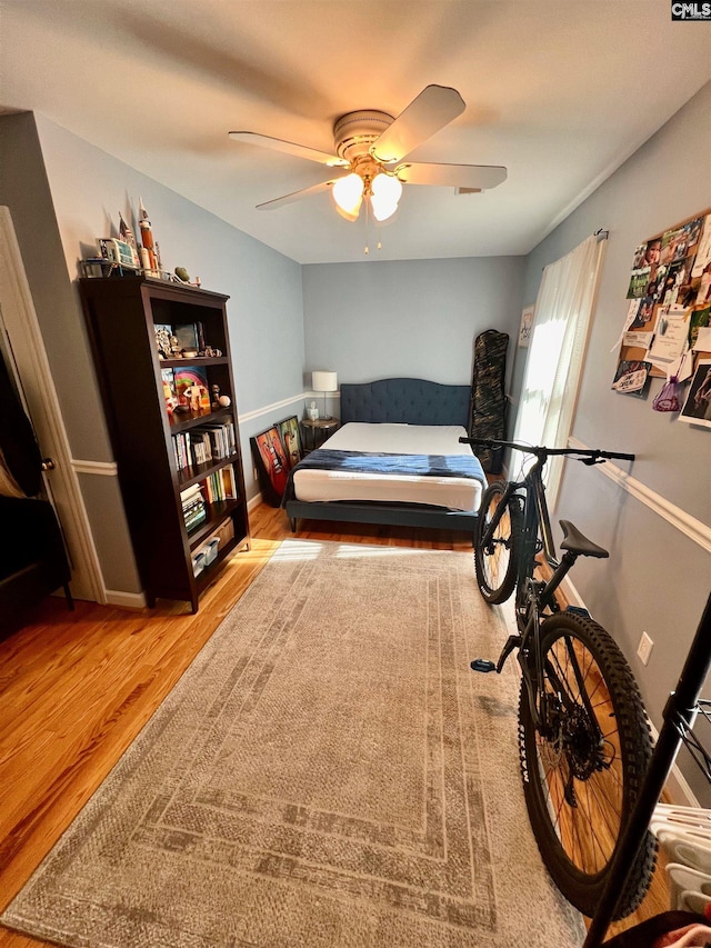 bedroom with ceiling fan and wood-type flooring