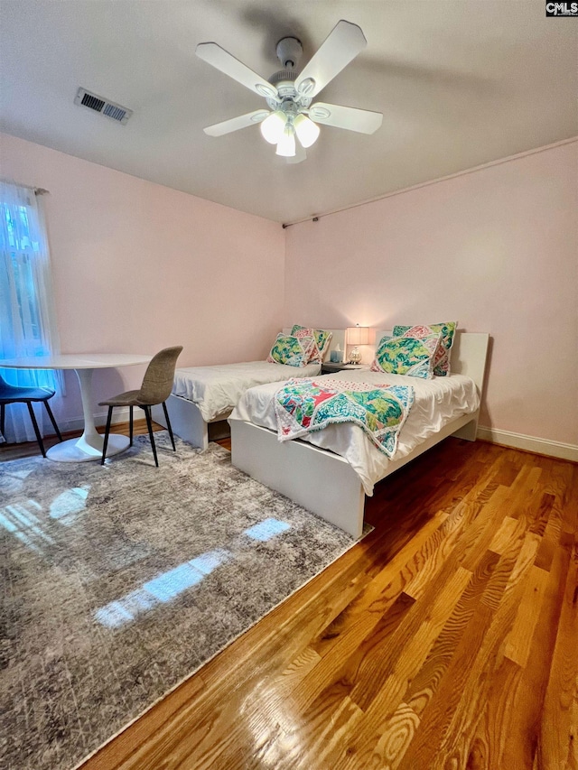 bedroom with hardwood / wood-style flooring and ceiling fan