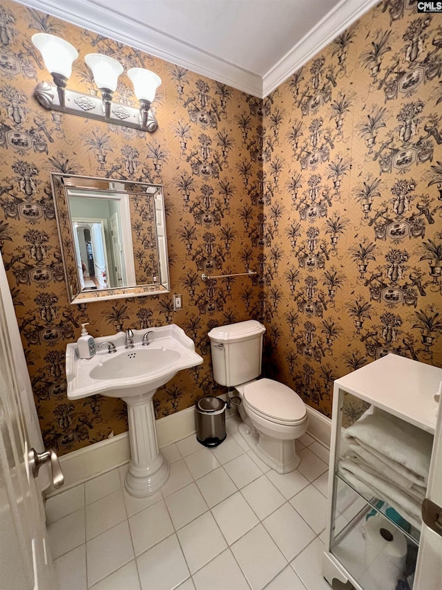 bathroom with tile patterned floors, toilet, and ornamental molding