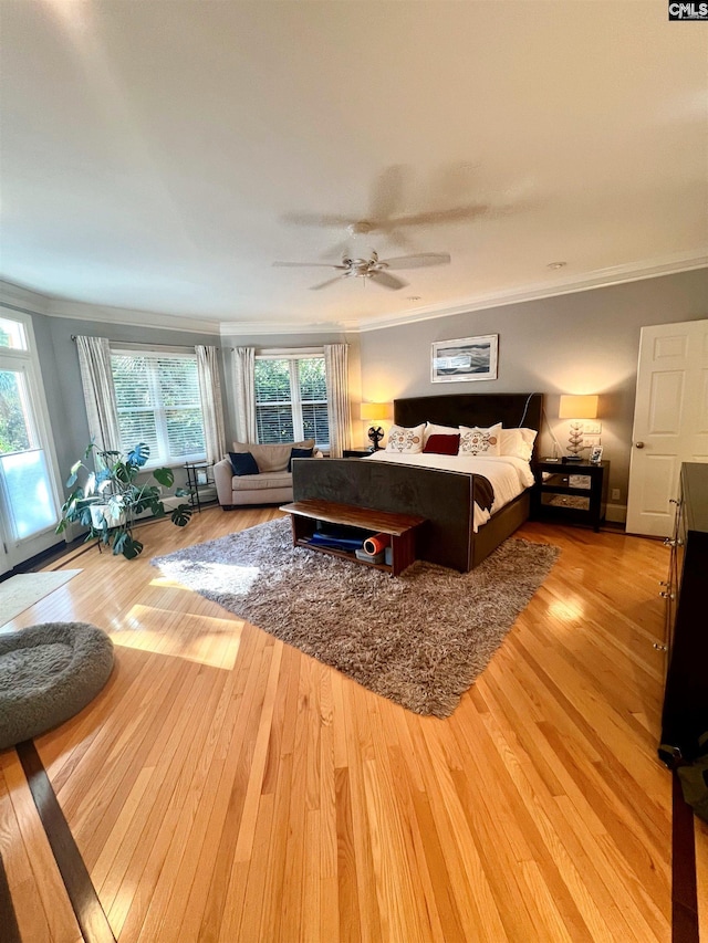 bedroom with hardwood / wood-style flooring, multiple windows, and ceiling fan