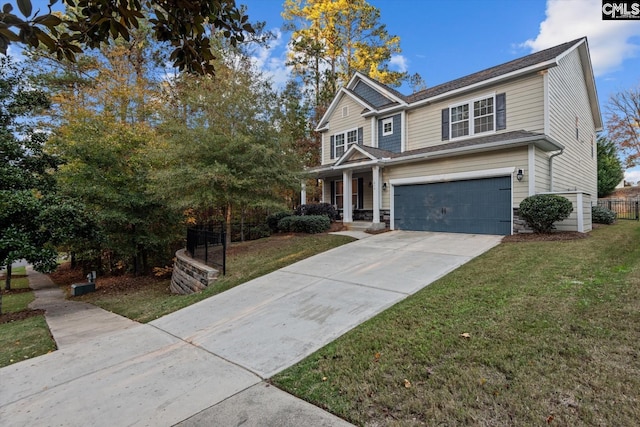 view of front of house with a front yard and a garage