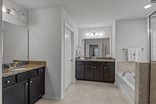 bathroom featuring tile patterned flooring, vanity, and independent shower and bath