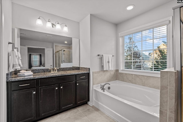 bathroom featuring tile patterned flooring, vanity, and separate shower and tub