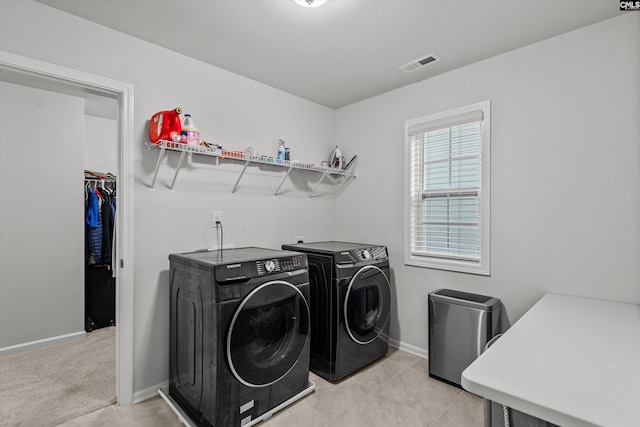 washroom featuring light carpet and washer and dryer