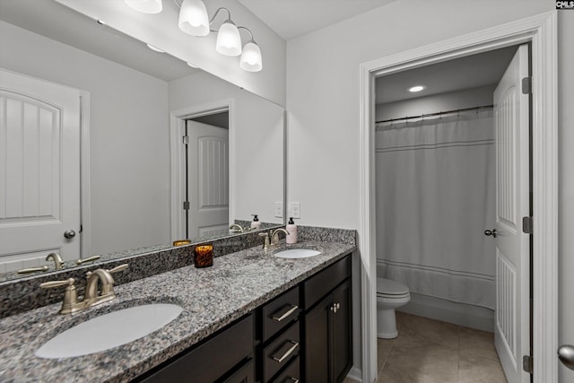 bathroom featuring tile patterned floors, vanity, and toilet