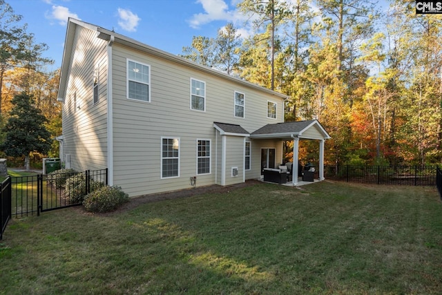 back of house with outdoor lounge area, a yard, and a patio