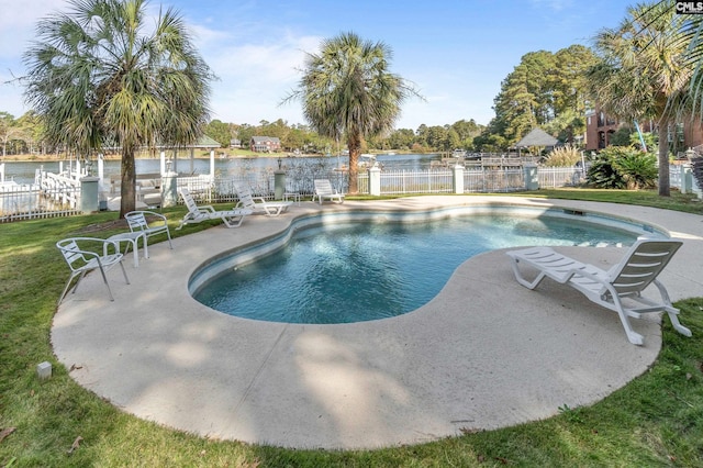 view of pool with a water view and a patio