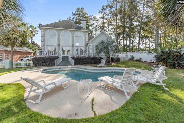 view of swimming pool with a yard and a patio