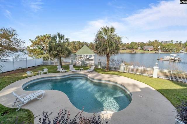 view of swimming pool with a water view and a lawn