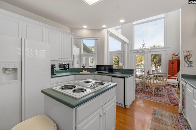 kitchen featuring white cabinets, french doors, white appliances, and light hardwood / wood-style floors