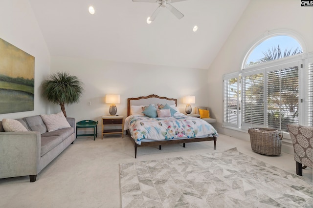 carpeted bedroom with ceiling fan and high vaulted ceiling