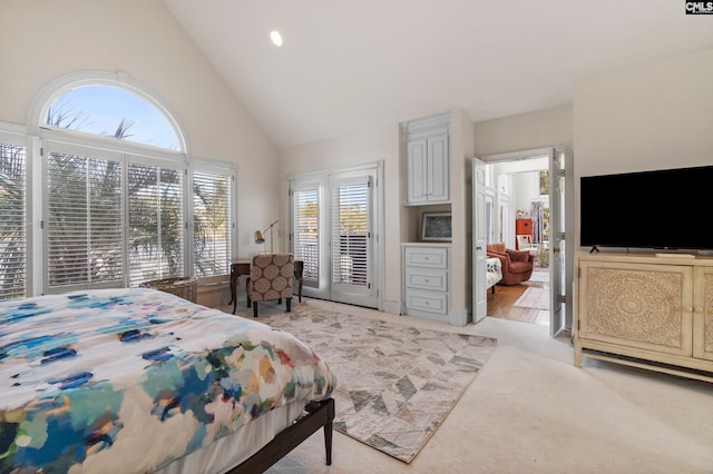 carpeted bedroom featuring high vaulted ceiling, access to outside, and multiple windows